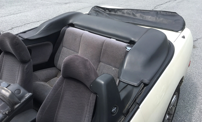 The hard to find tonneau cover was a gift from Cox’s girlfriend. The white pieces sticking up behind the seats are the clips he made.